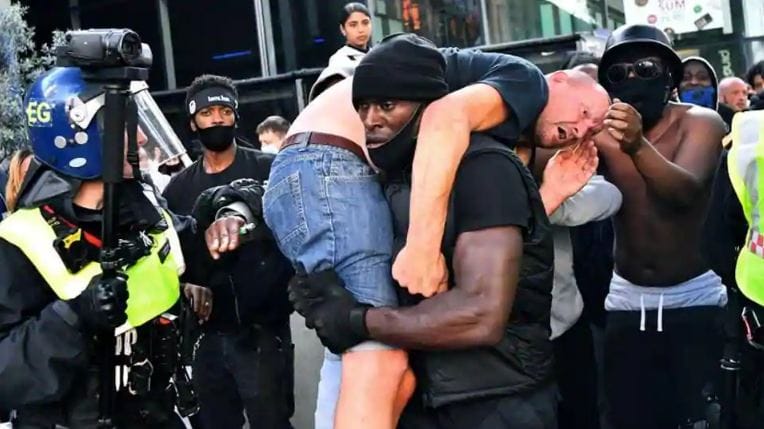 London: Two groups clash in anti-racist demonstrations, black protesters carry white injured man safely on shoulder