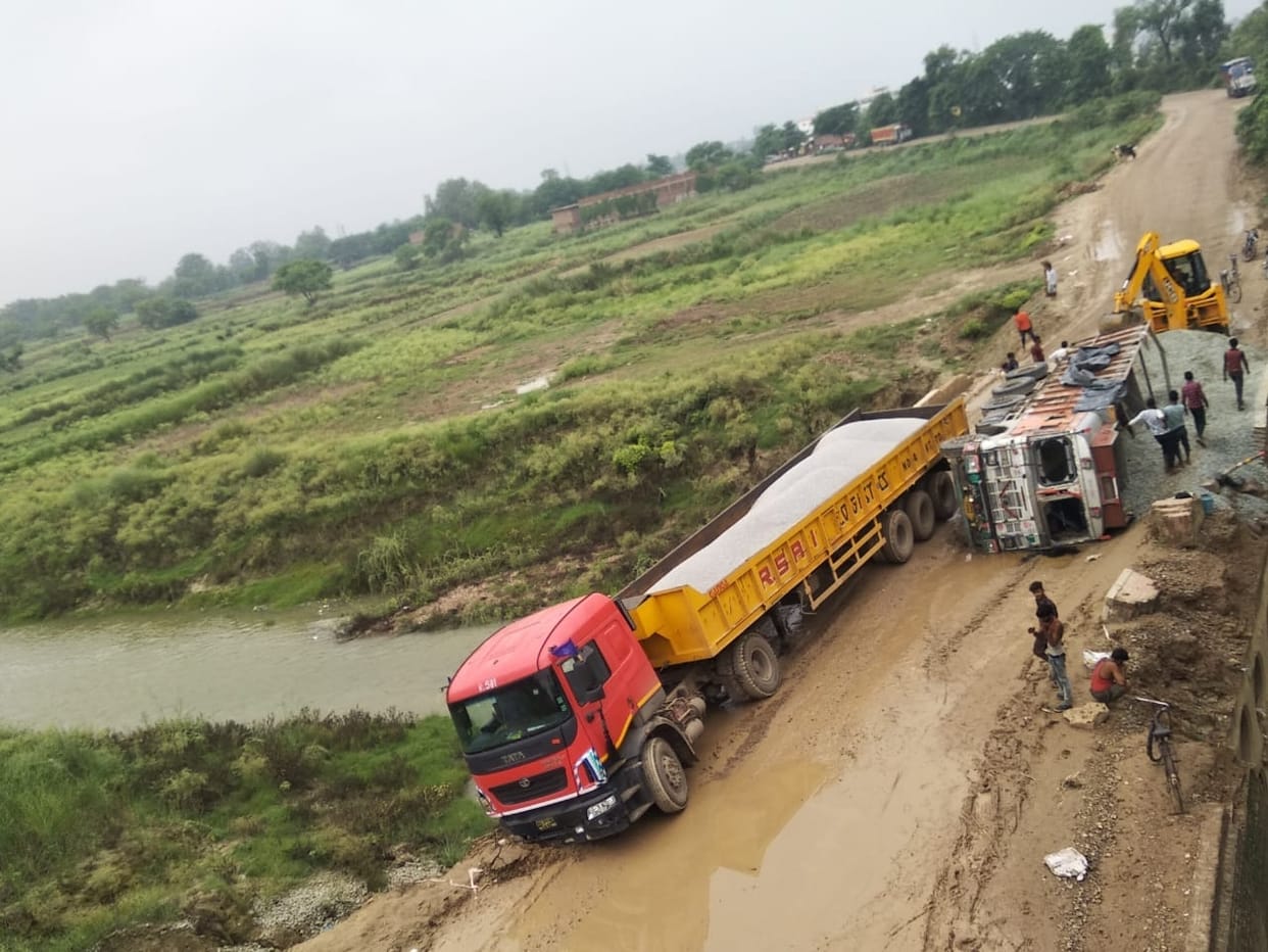 Ballast filled truck overturns, jammed for hours