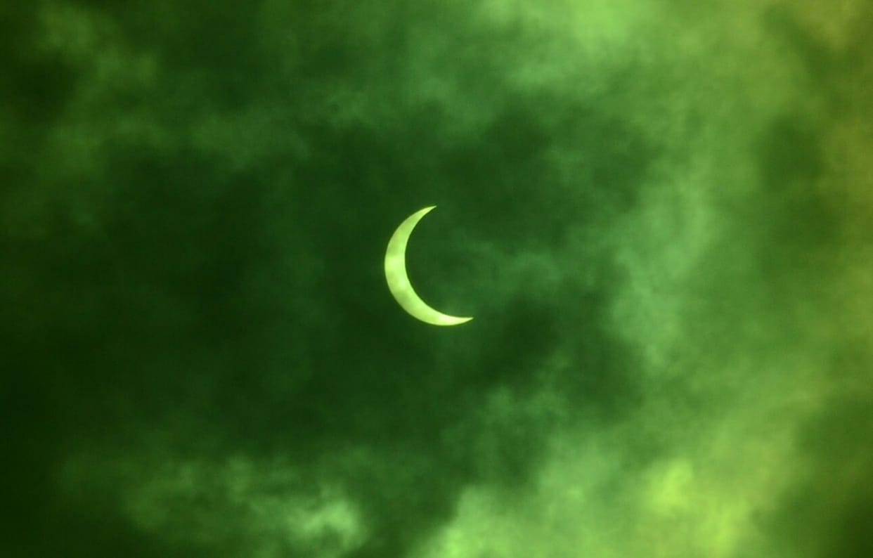 The midday sun has turned moon, staring at the sky