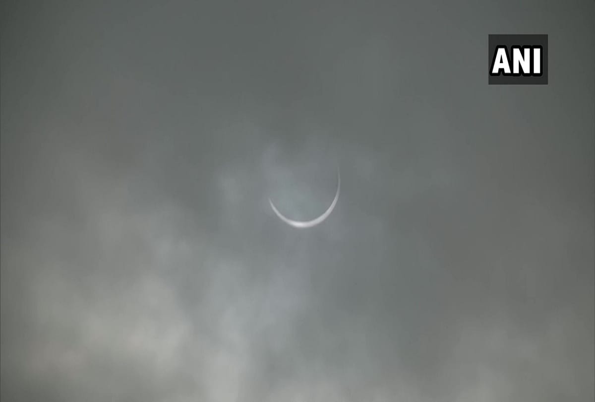 Solar eclipse 2020 seen in delhi NCR pictures of moon covering sun in cloudy sky