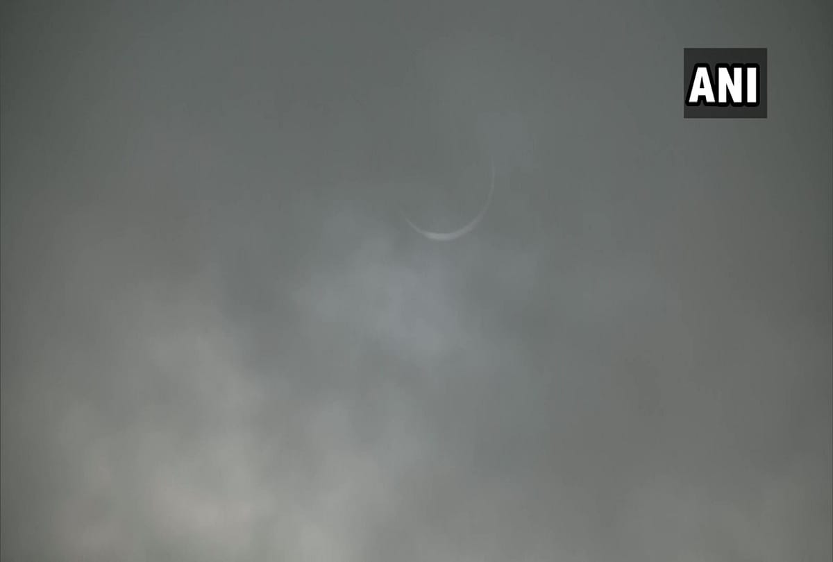 Solar eclipse 2020 seen in delhi NCR pictures of moon covering sun in cloudy sky