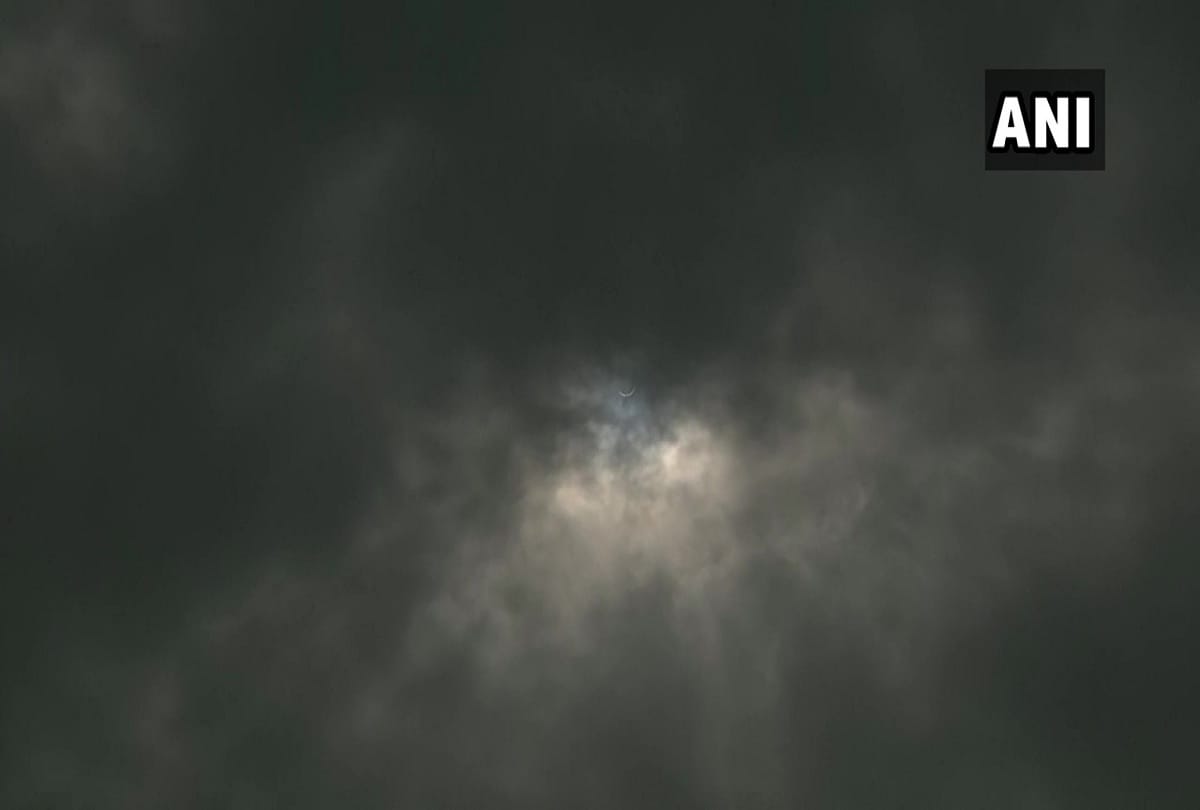 Solar eclipse 2020 seen in delhi NCR pictures of moon covering sun in cloudy sky