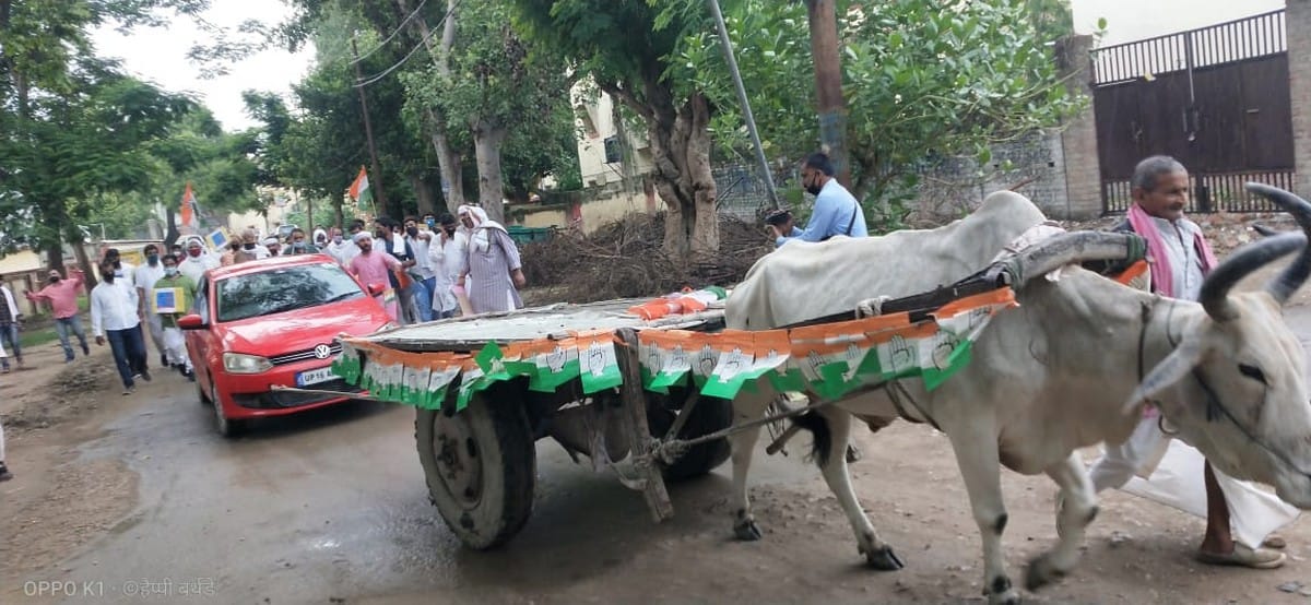 Congress workers pull car from bullock cart to protest petrol and diesel price hike in varanasi