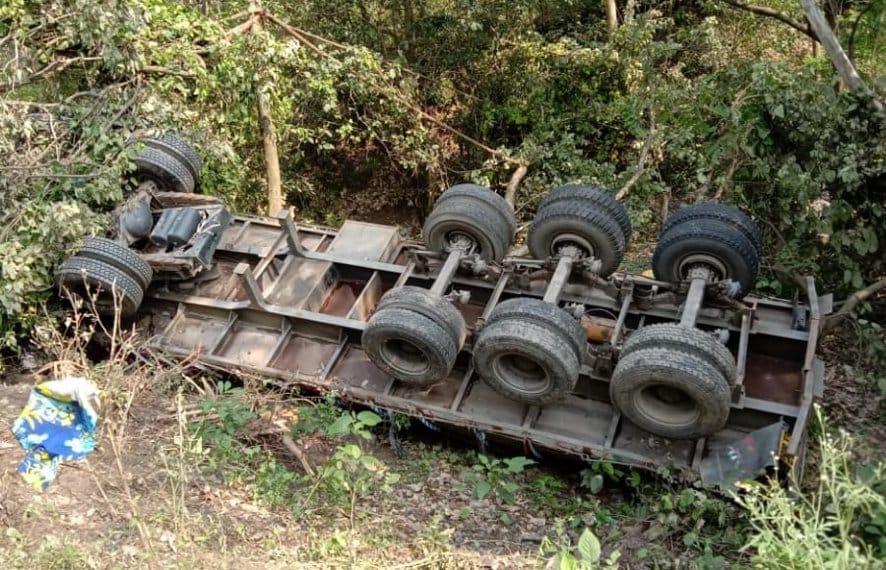 Truck overturns, driver and helper injured