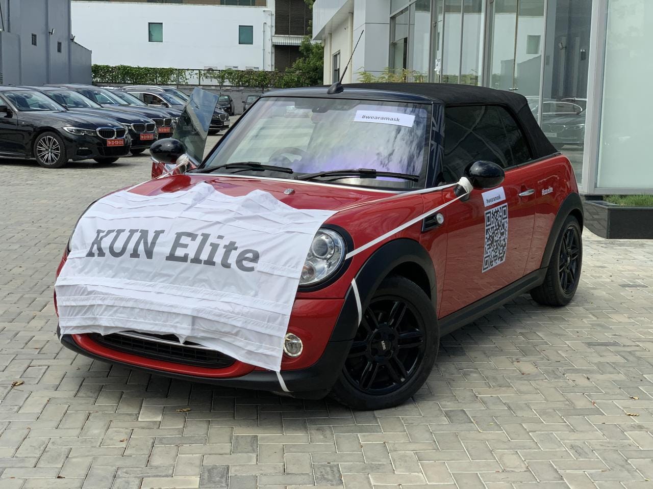 To promote used car sales during covid 19, dealer made dressed a mini cooper car in a mask