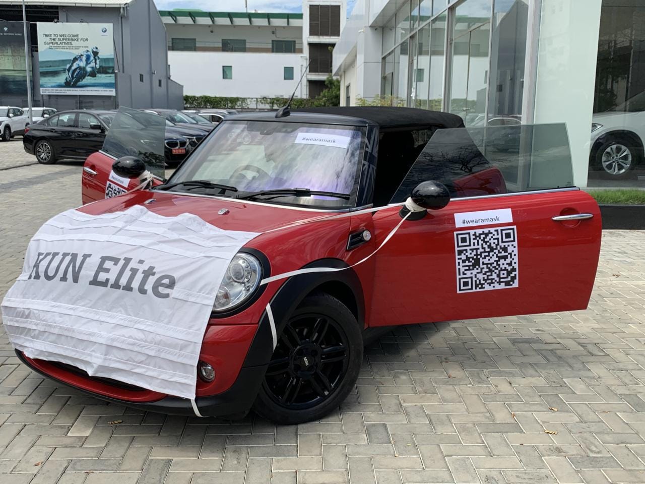 To promote used car sales during covid 19, dealer made dressed a mini cooper car in a mask