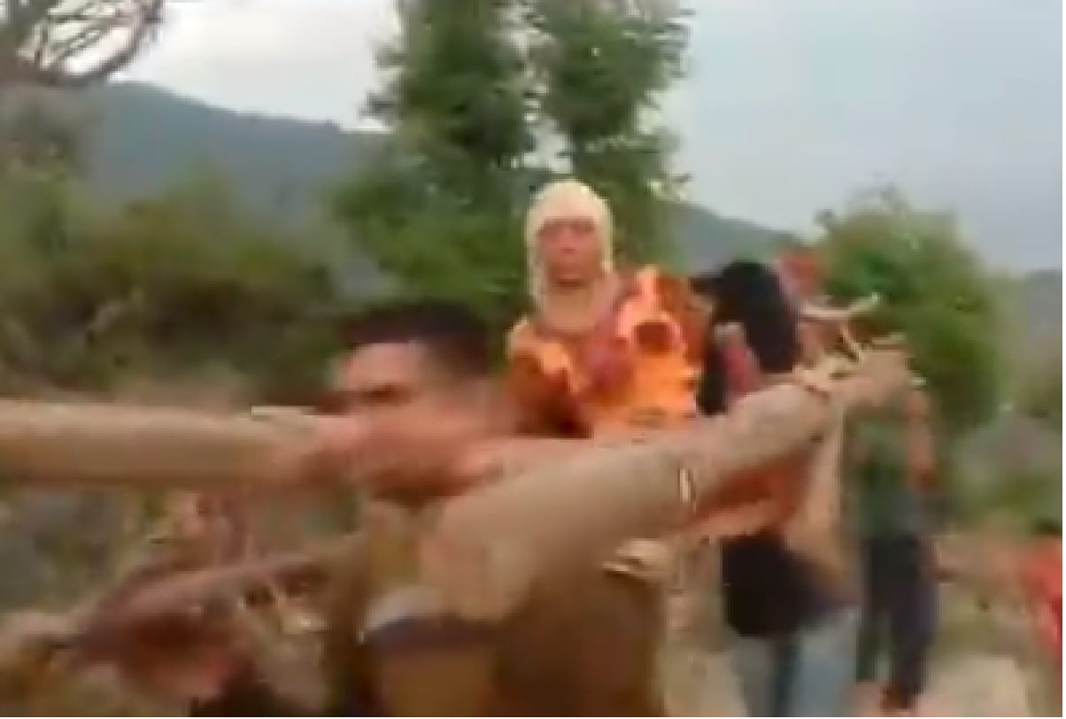 patient carried on makeshift stretcher made of wooden logs by villagers in Doda jammu kashmir