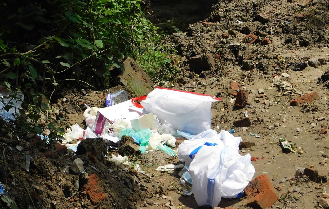 Used PPE kit and medical vest thrown in front of CMO house in Ballia