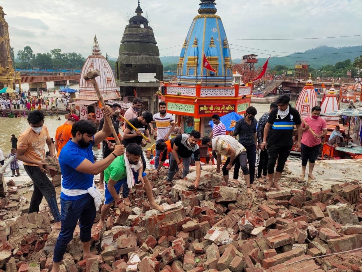 Removing the wall debris that fell on his feet