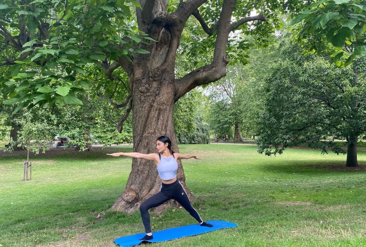 mouni roy pics latest doing yoga poses in garden glamorous look