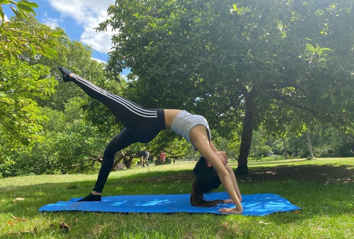 mouni roy pics latest doing yoga poses in garden glamorous look