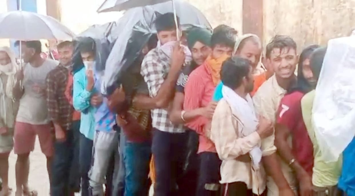 A crowd of farmers gathered at the warehouse for urea