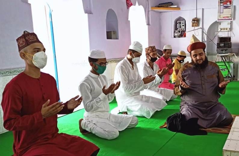 Muslim brothers offer Eid-ul-Azha prayers at home