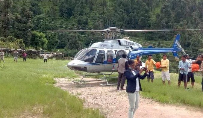 Helicopter transporting women and children stranded in villages to relief camp