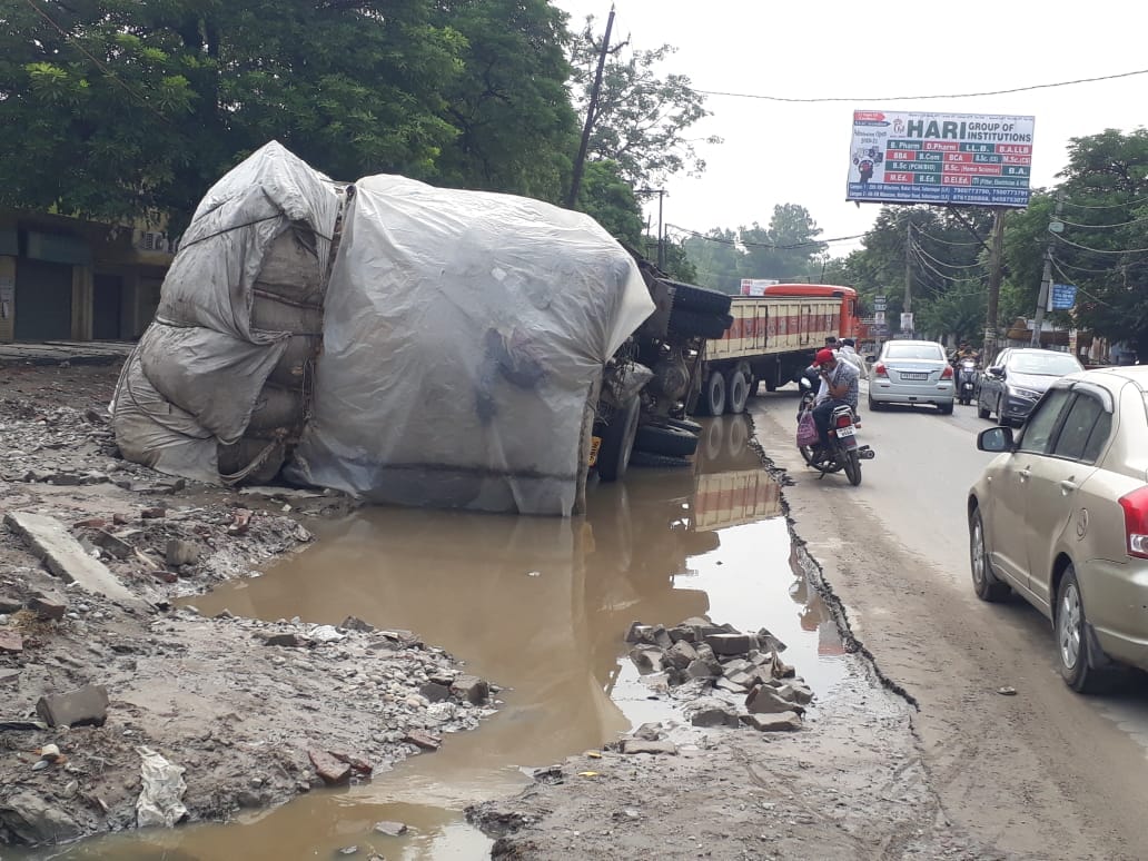 Truck overturned due to flooding on construction road