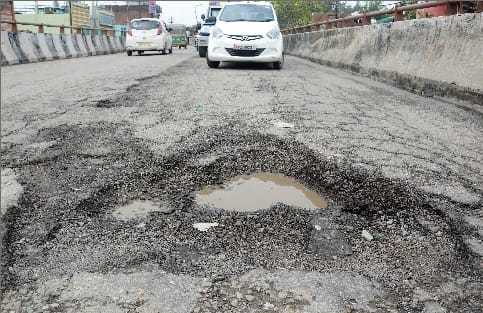 Traffic on Badaun Road gets stuck in deep pits on Chaupula overbridge