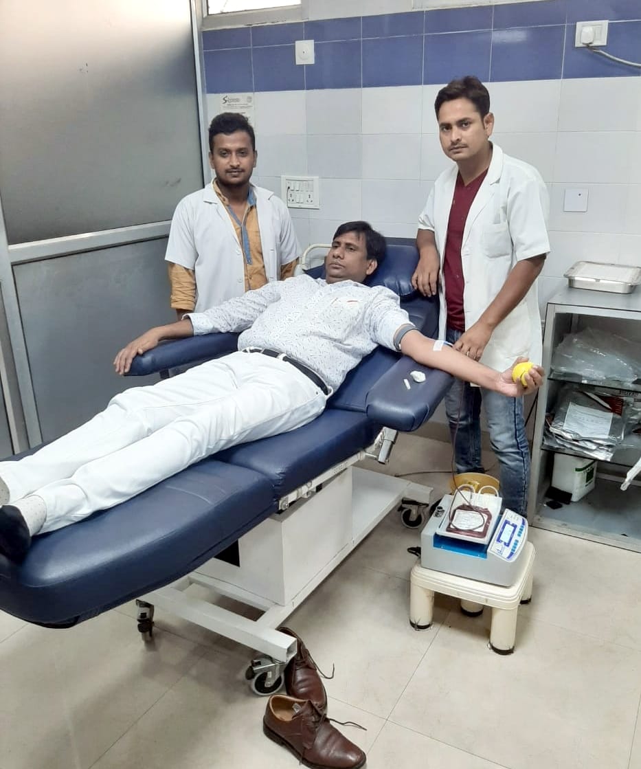 The chairperson's husband saved the life of the District President of the Board of Trade by giving blood