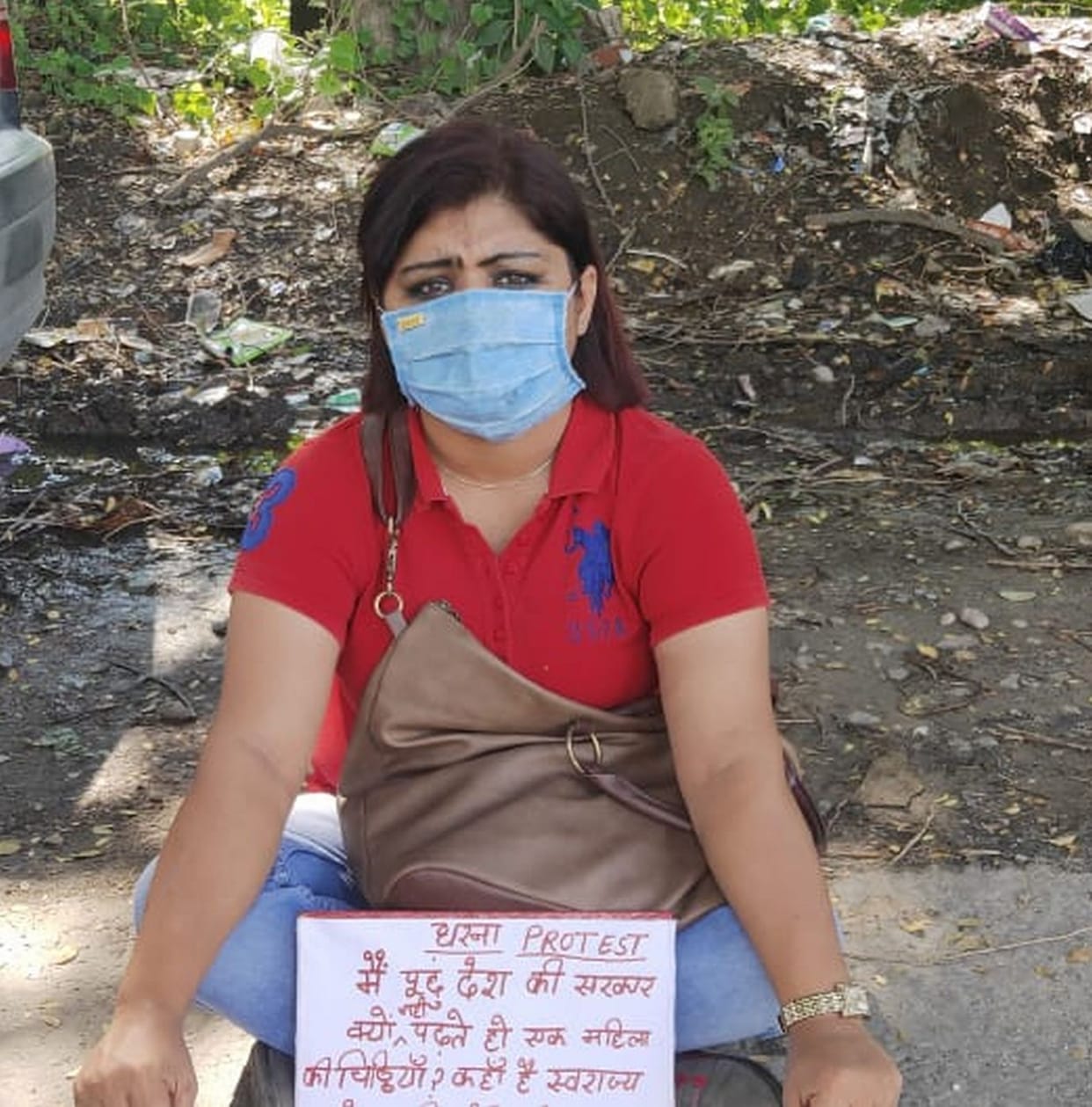 A woman sitting on a highway on the highway against in-laws