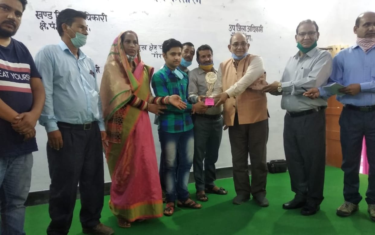 MLA honored board topper