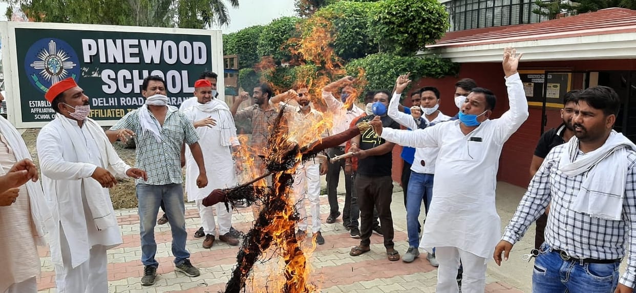 Protest expressed by blowing the effigy of the school operator