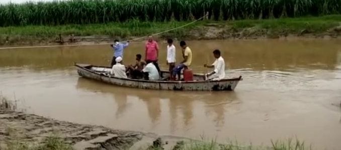 Villagers have to cross the Solani river by boat