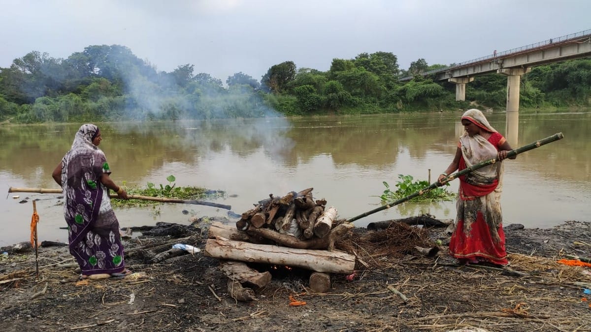 Two women handling life by burning bodies on cremation grounds in jaunpur