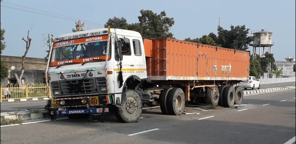 Car collides with truck parked on highway, youth dies