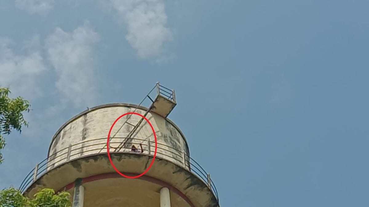 Woman with child climb on water tank against lekhpal demanding bribe from her in bhadohi up