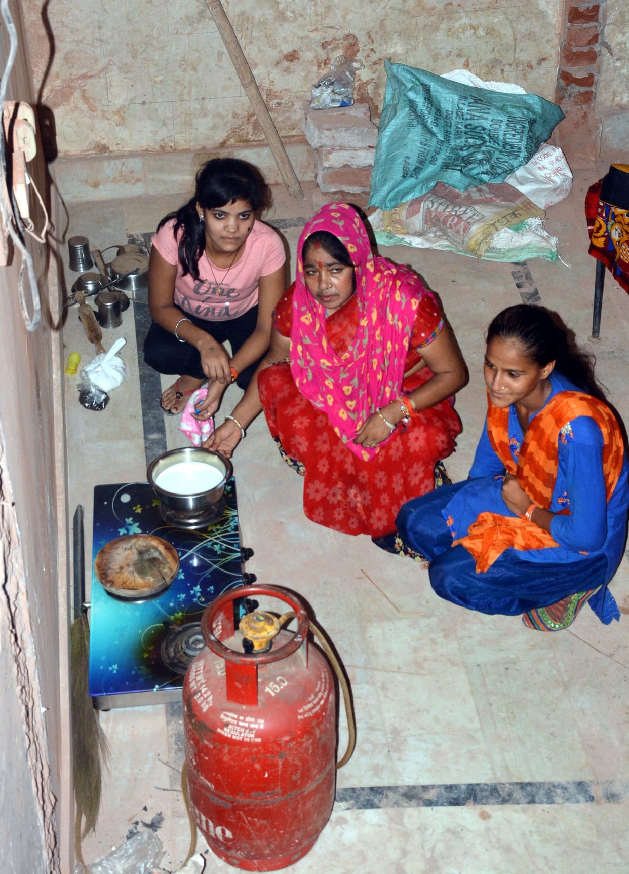 Mother daughters sitting on dharna in bullion market with charp-stove