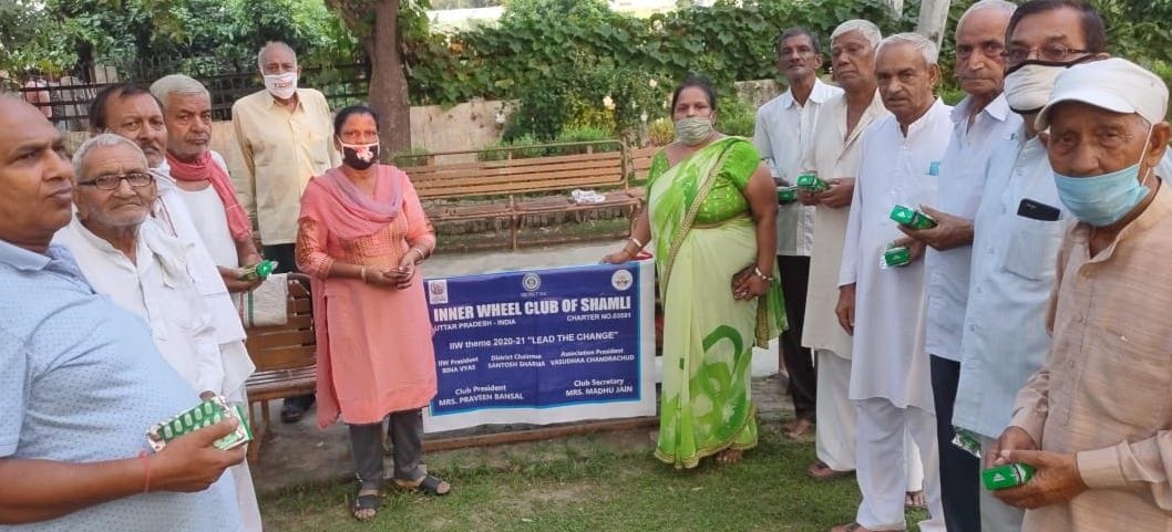Distribute biscuits to senior citizen