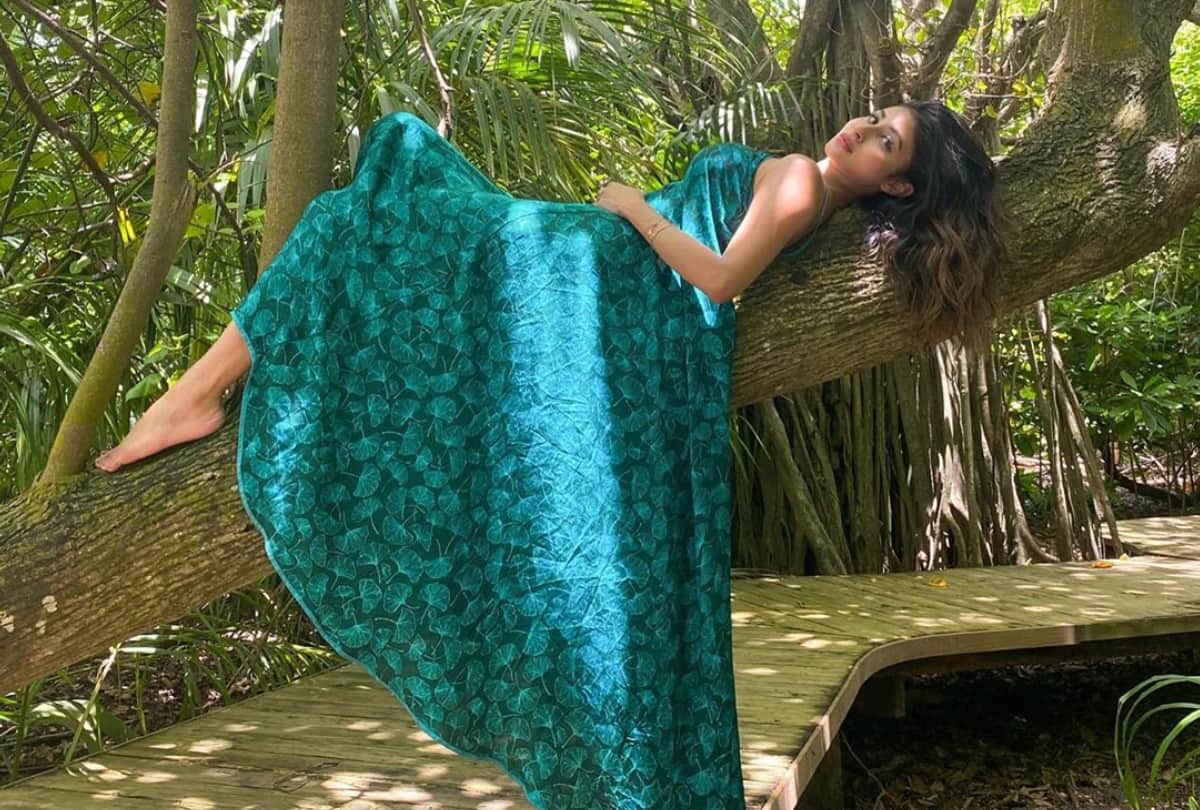 mouni roy latest vacation sizzling pic in green dress poses on the tree