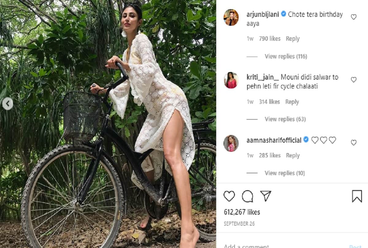 mouni roy latest vacation sizzling pic in green dress poses on the tree