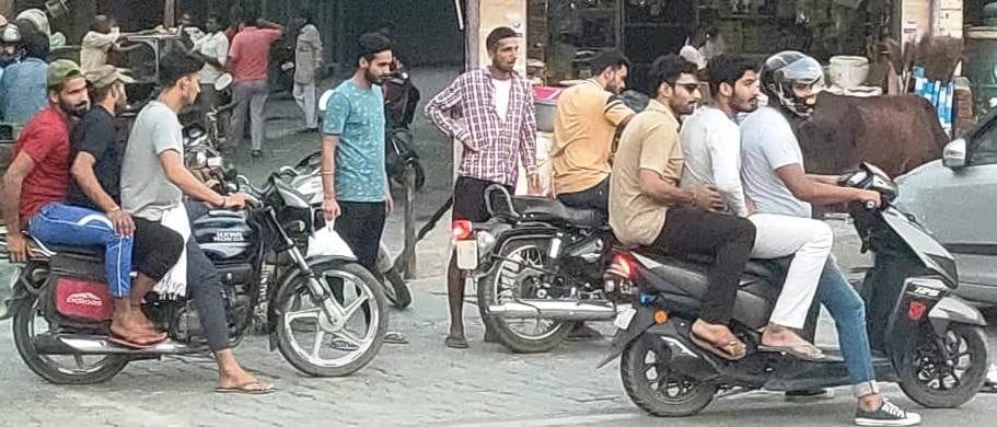 Three or three people travel on a bike