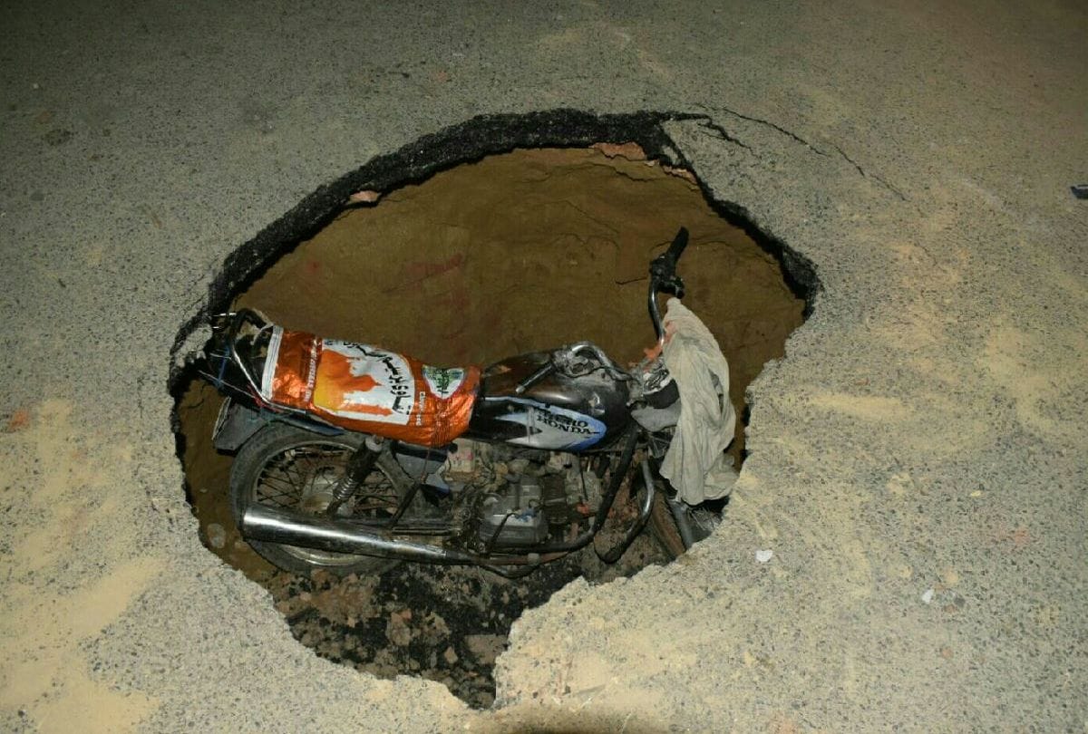 bike fell out in pothole after road collapse in agra