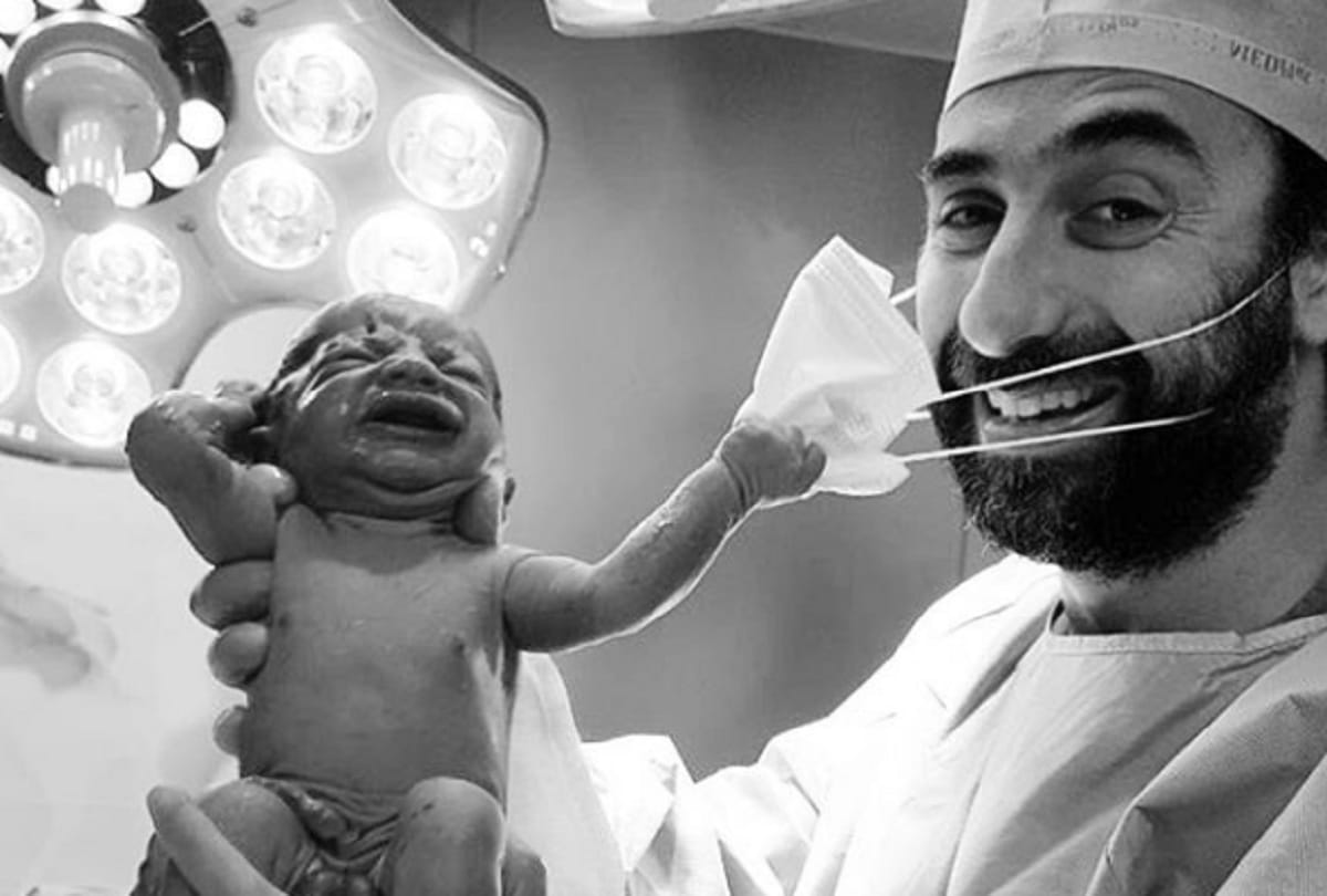 Picture of new born baby pulling mask of doctor goes viral