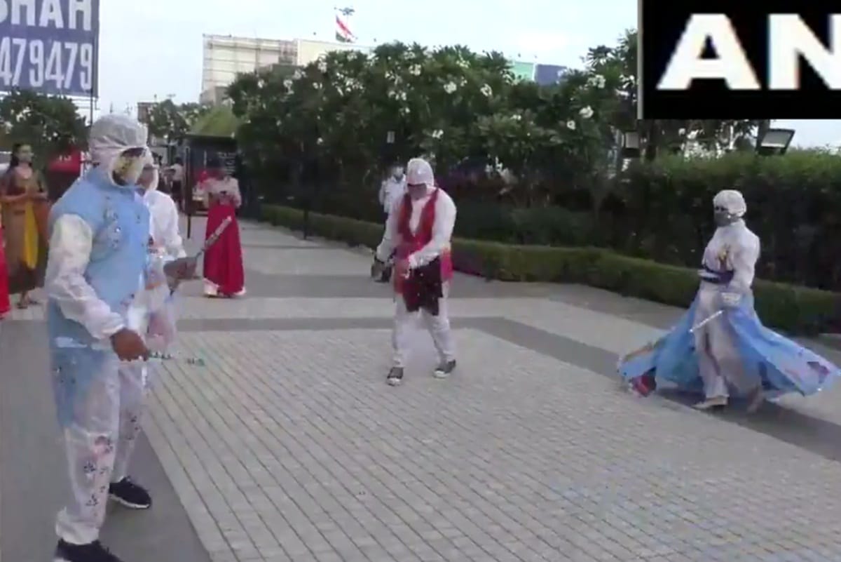 gujarat fashion designing students in surat perform garba sporting hand painted costumes made of PPE kits