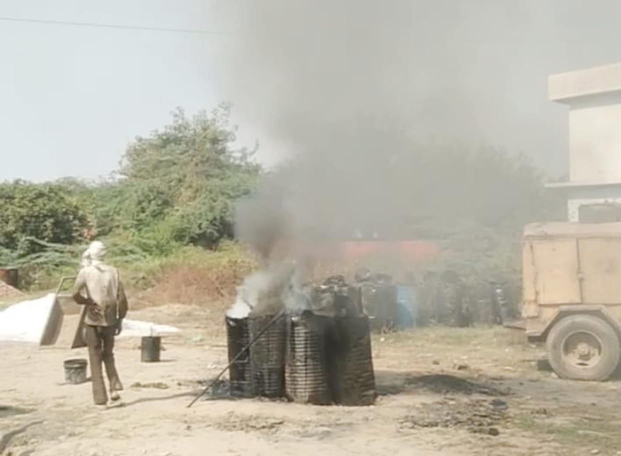 Coal tar being melted in the market, smoke rising