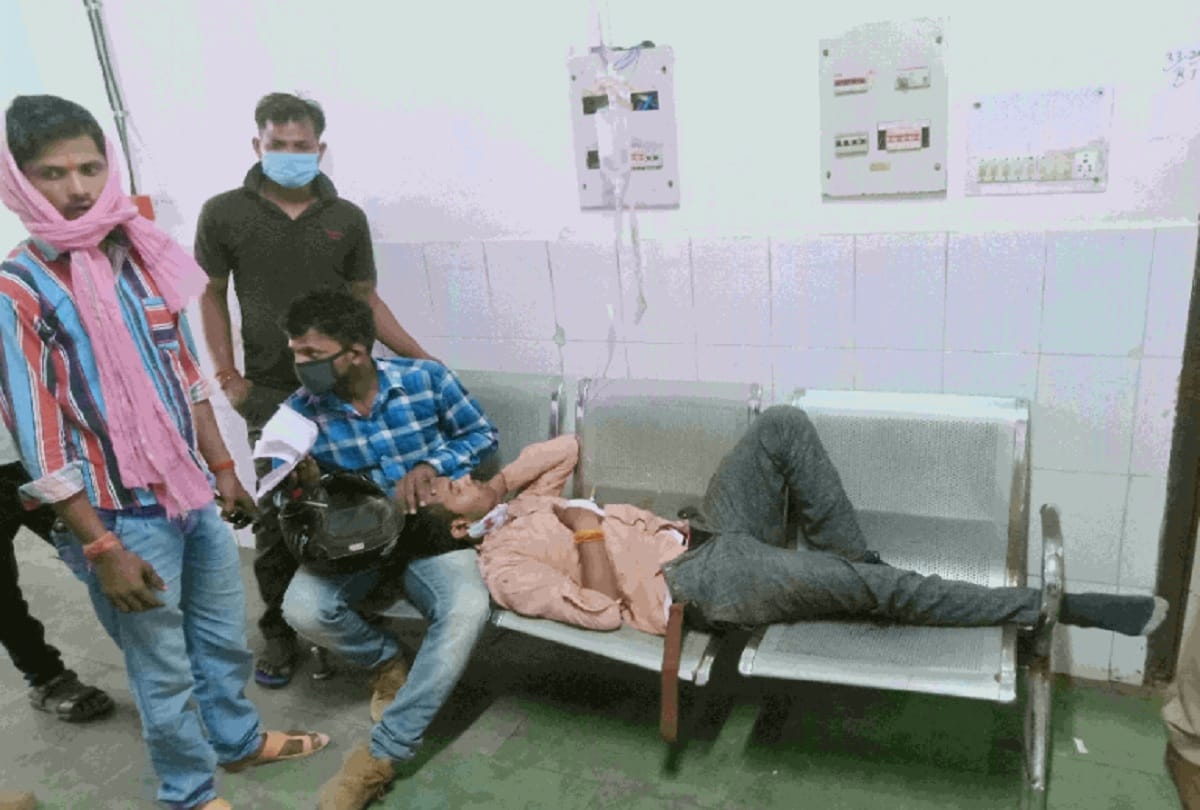 Patient lying on the bench hangs bottle of glucose from an electric board in jhansi