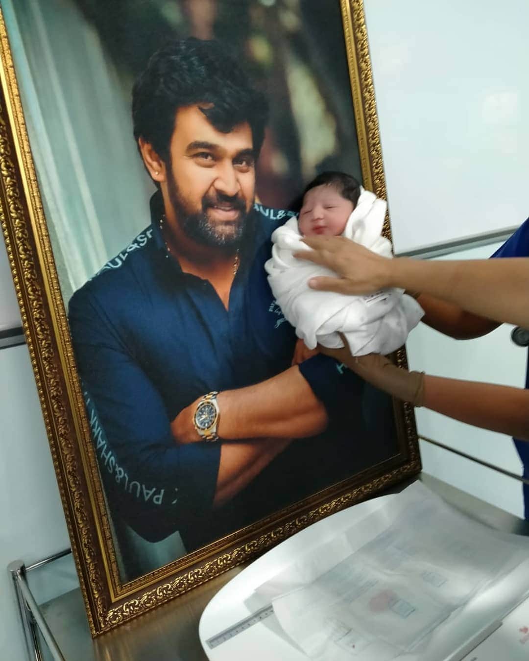 Meghana Raj at her sons cradle ceremony revealed a painting of Chiranjeevi Sarja with his son Jr Chiru