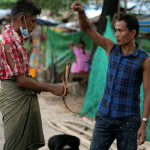 A man sells eels in a slum area of Yangon Myanmar