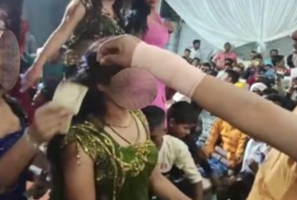 Officers dance with bar girls in Bahraich.