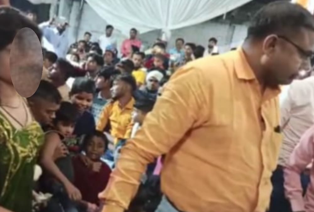 Officers dance with bar girls in Bahraich.