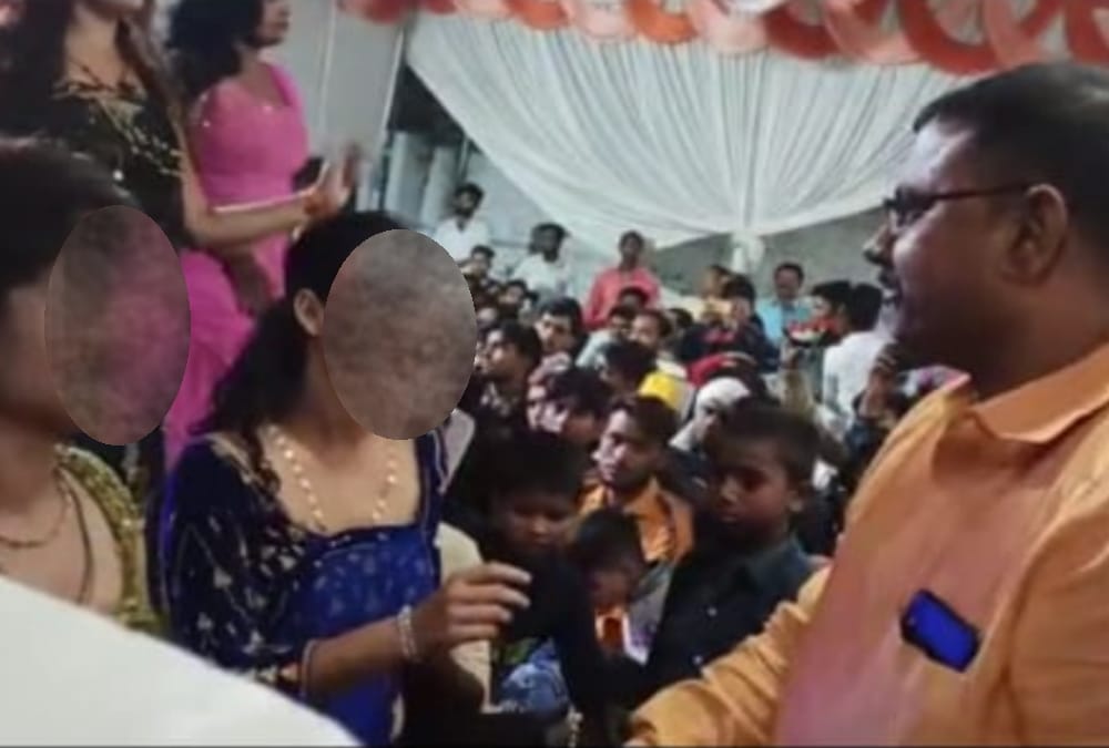 Officers dance with bar girls in Bahraich.