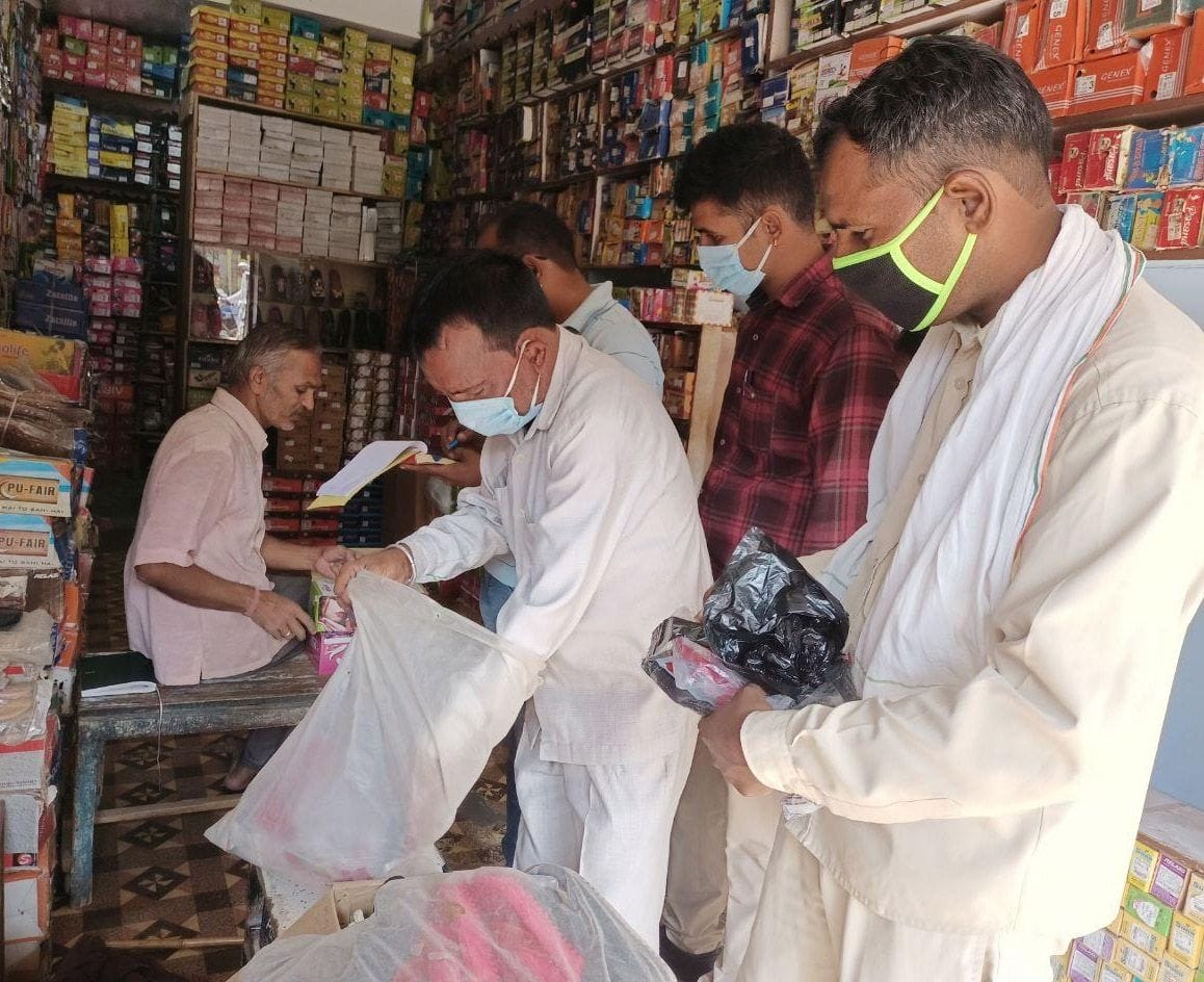 Shopkeepers holding polythene cut invoices