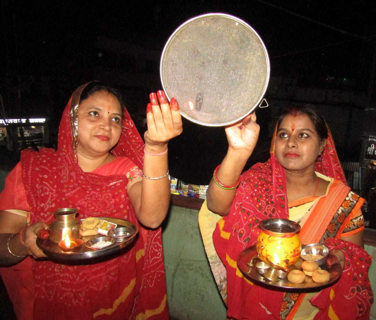 women showed the moon with a sieve