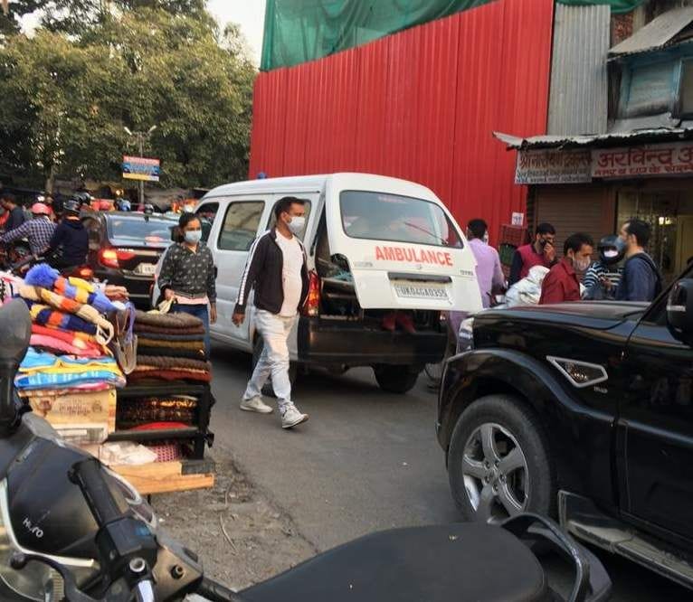 Vehicles crawling on roads during the day, ambulances stuck in jam
