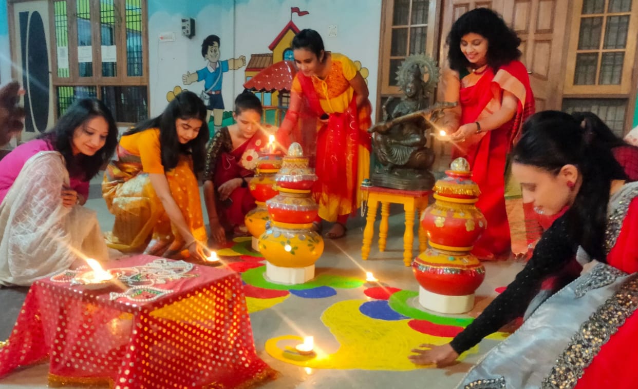 Decorated colorful rangoli, lighted lamp burn