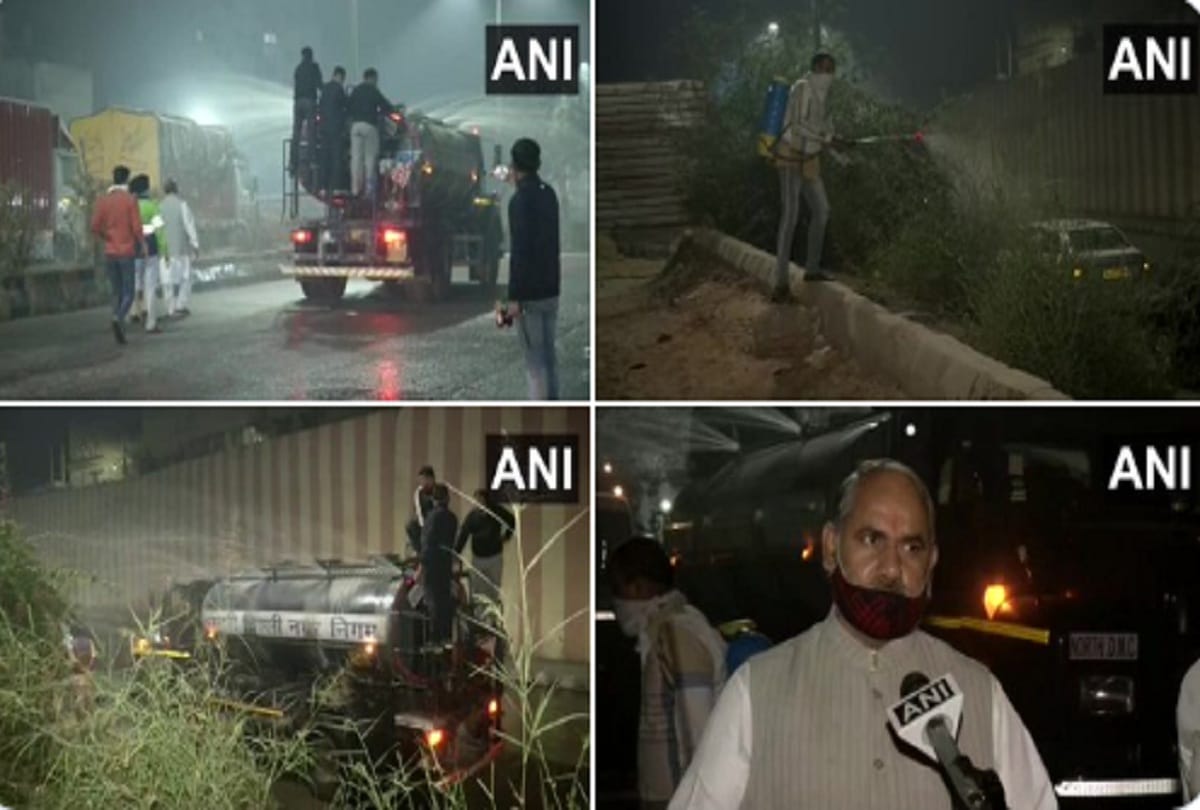 North Delhi Municipal Corporation conducts water sprinkling in Sadar Bazaar area as a measure against air pollution