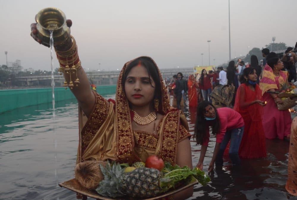 Women offer prayer on Chhath Pooja.
