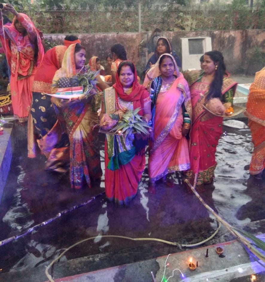 Worshiping standing in water, offering prayers to the setting sun